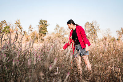 Full length of woman on field against sky