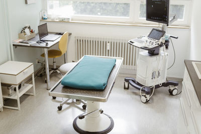 Examination table in operating room at clinic