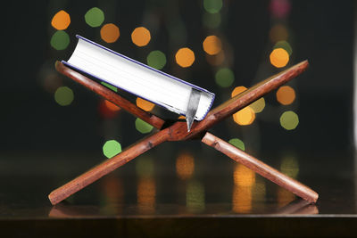 Close-up of book on stand at table