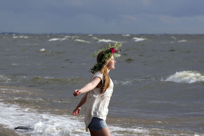 Woman running on beach near sea