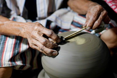 Close-up of man making pottery