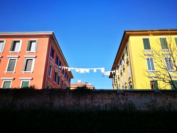 Low angle view of buildings against blue sky