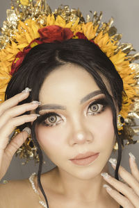 Close-up portrait of young woman with balinese traditional wedding