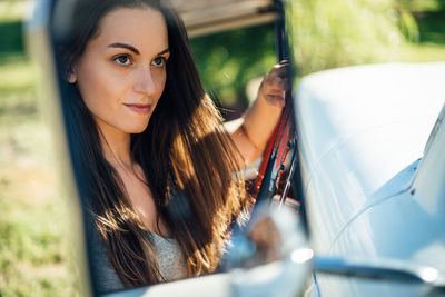 Portrait of beautiful woman in car