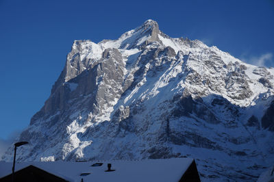 Snowcapped mountains against clear blue sky