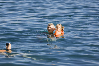 Full length of shirtless man swimming in sea