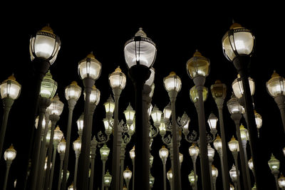 Low angle view of illuminated lights hanging at night