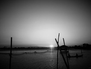 Boats in sea at sunset