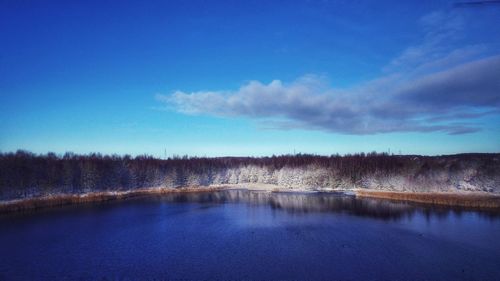 Scenic view of lake against blue sky