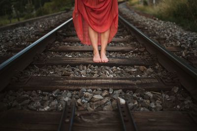 Low section of man standing on railroad track