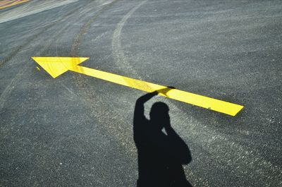 Shadow of man on street