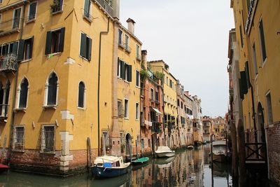 Venetian, venice waterway, venetian architecture, moored boats, shutters, flowers in windows, italy
