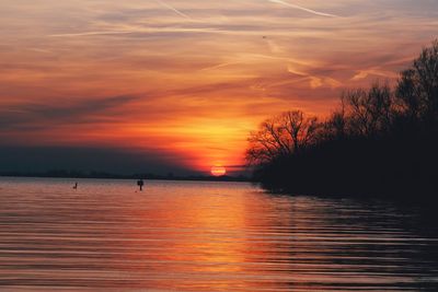 Scenic view of lake against romantic sky at sunset