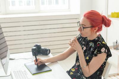 Woman smoking vape while working at home