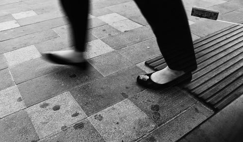 Low section of people standing on tiled floor