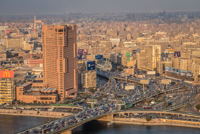 High angle view of bridge over river amidst buildings in city