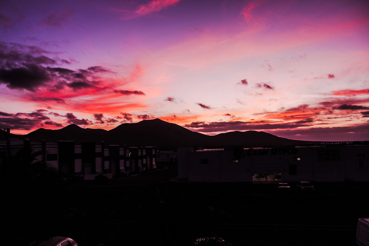 sky, sunset, cloud, architecture, dawn, mountain, evening, building exterior, built structure, nature, afterglow, city, beauty in nature, building, dramatic sky, no people, silhouette, pink, darkness, outdoors, night, mountain range, travel destinations, scenics - nature, house, red sky at morning