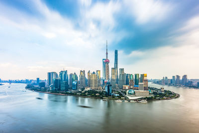 View of buildings in city against cloudy sky