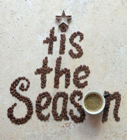 Close-up of text formed through coffee beans on table