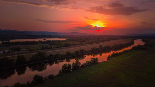 Scenic view of landscape against romantic sky at sunset