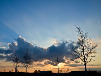 Silhouette landscape against blue sky