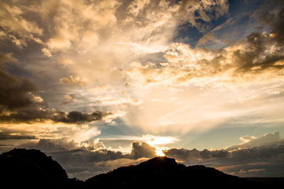 Low angle view of silhouette mountains against sky during sunset