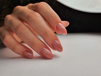 Close-up of woman hand over white background