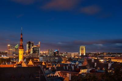 Illuminated buildings in city against sky