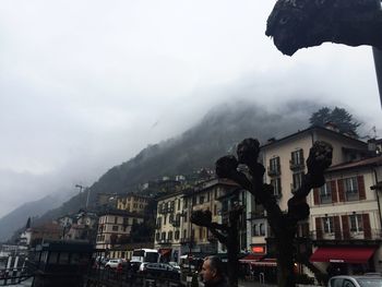 Houses against cloudy sky