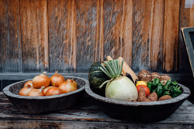 High angle view of vegetables in baskets on wooden table