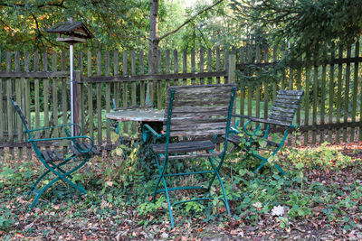 Empty chairs and tables in yard
