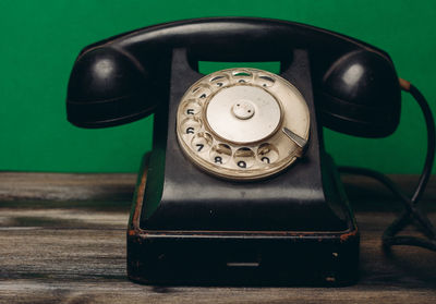 Close-up of old telephone on table