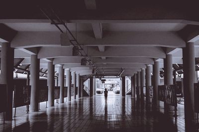 Woman standing in corridor of building