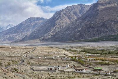 Scenic view of mountains against cloudy sky