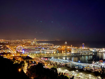 High angle view of city lit up at night