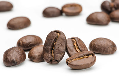 Close-up of coffee beans against white background