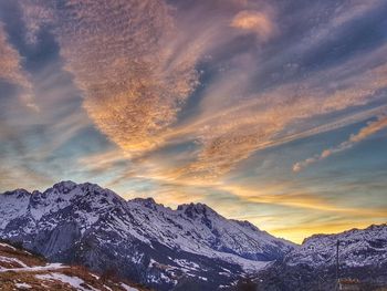 Scenic view of snowcapped mountains against sky during sunset