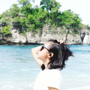 Woman wearing sunglasses in sea