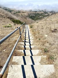 Shadow of railing on footpath