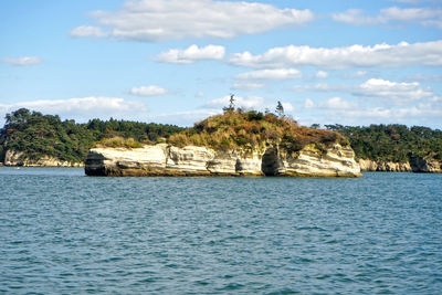 Scenic view of sea and buildings against sky
