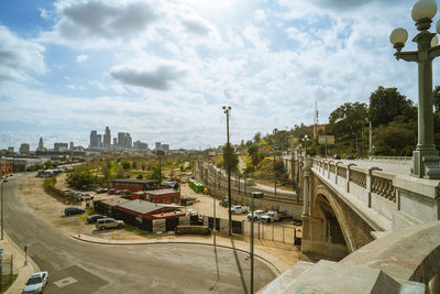 High angle view of road by buildings against sky