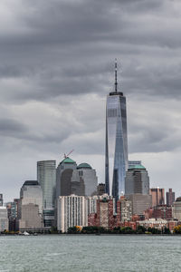 View of buildings in city against cloudy sky