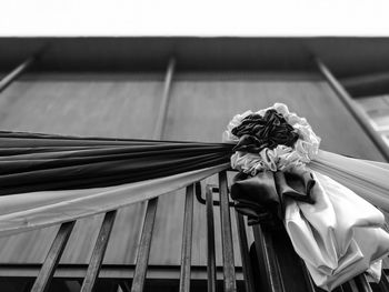 Low angle view of textiles tied to railing on building