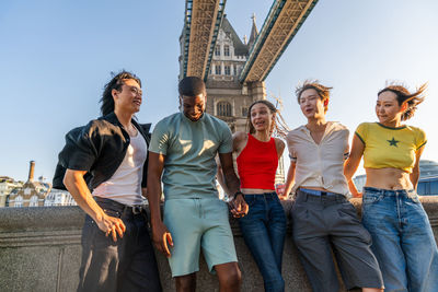 Group of friends standing against sky