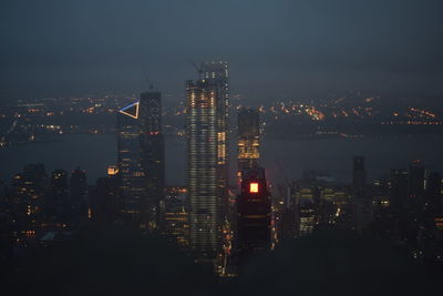 High angle view of illuminated buildings against sky at night