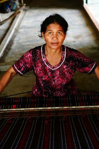High angle portrait of mature woman working in textile industry