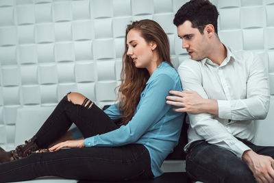 Young couple sitting on floor