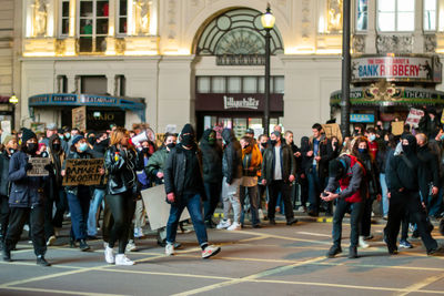 People walking on street in city