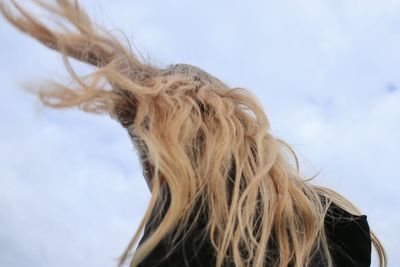 Close-up portrait of woman against sky