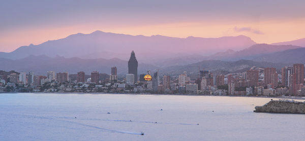 View of buildings in city during sunset